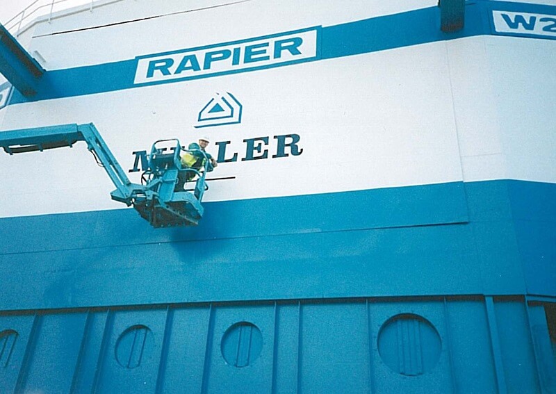 An image of a person installing signage against a blue background.